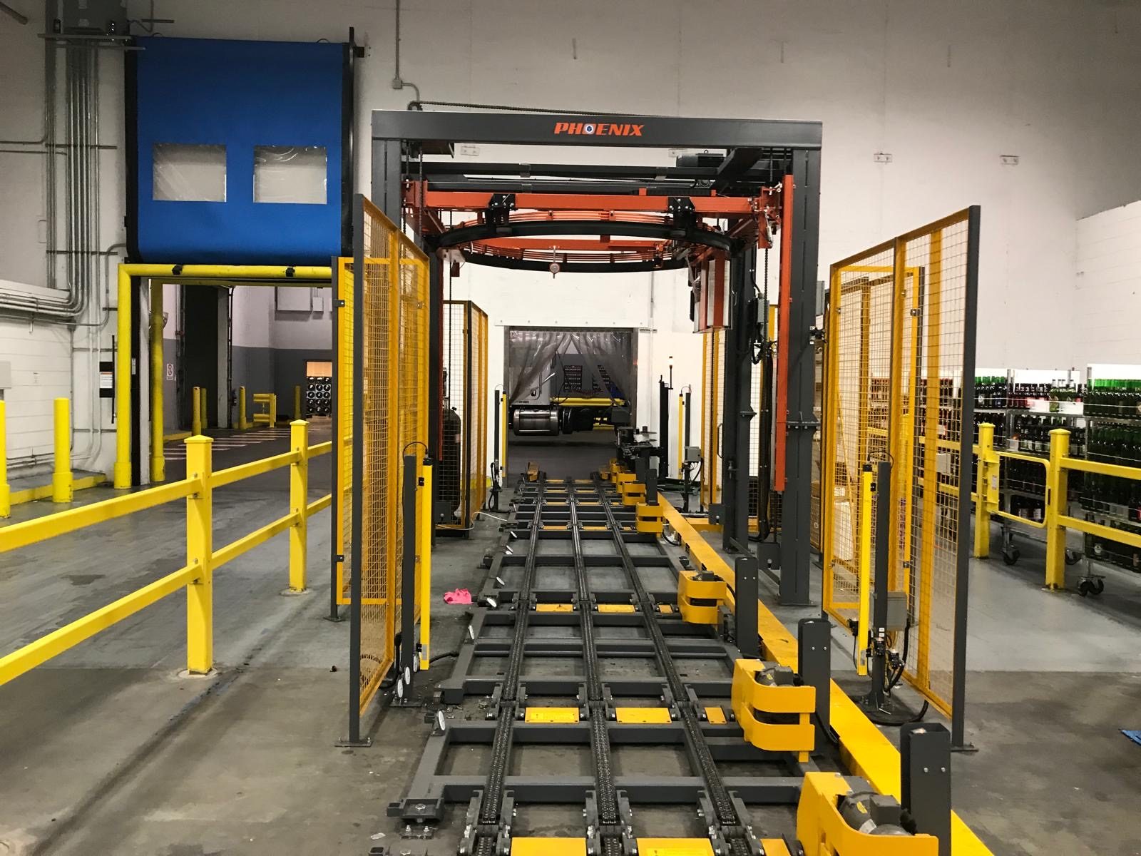 Phoenix ring stretch wrapper on a chain conveyor in a distribution facility
